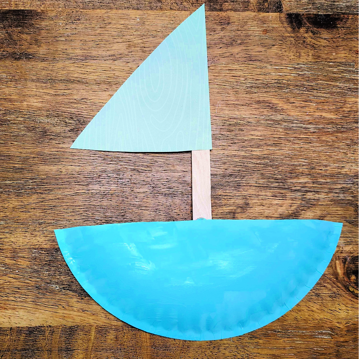Paper Plate Boat Craft- Step 4- Glue on your sail -Kids Activities Blog