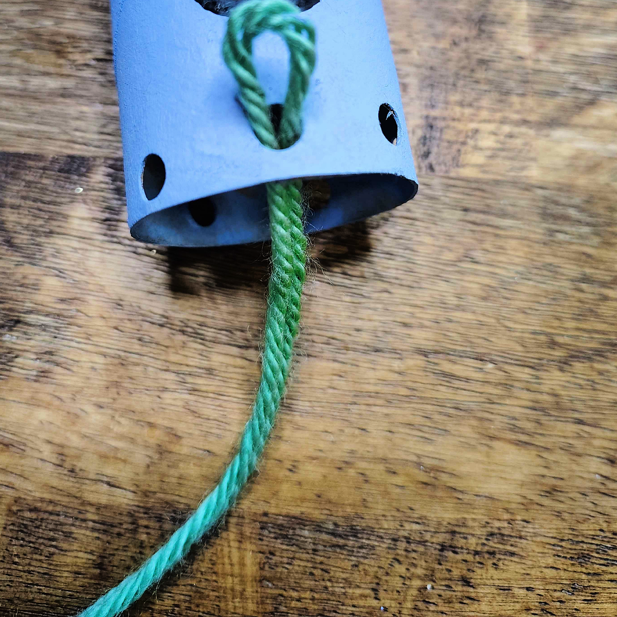 Toilet Paper Roll Octopus Roll- Step 5- Loop your yarn through the hole-Kids Activities Blog