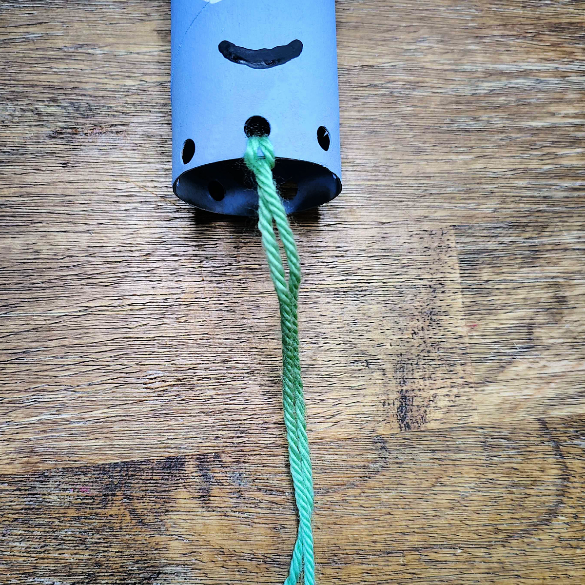 Toilet Paper Roll Octopus Roll- Step 6- Pull the tails through the loop-Kids Activities Blog