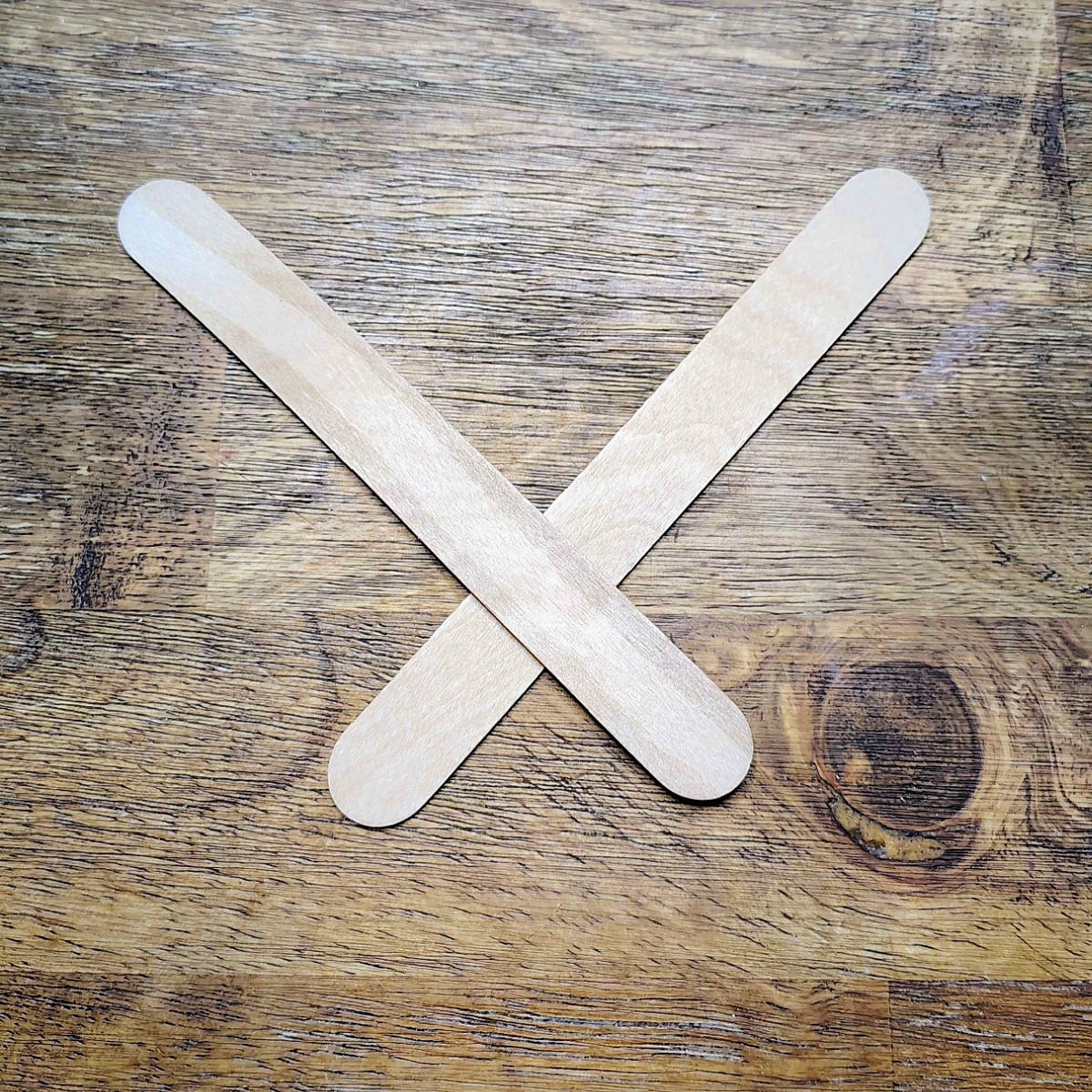 Paper Plate Fan- step 11 -  Glue two jumbo popsicle sticks together, the popsicle sticks need to make an x at the bottom.-Kids Activities Blog