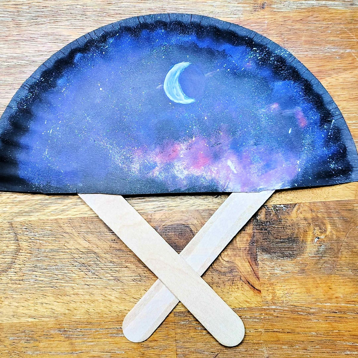 Paper Plate Fan-Step 12 - Hot glue the crossed popsicle sticks to the paper plate and you're done. -Kids Activities Blog