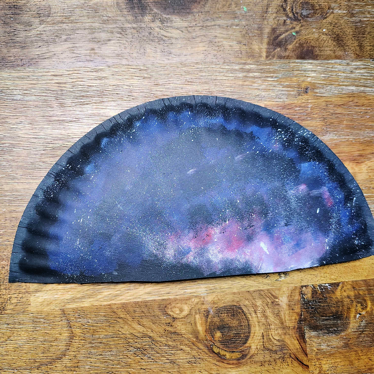 Paper Plate Fan-Step 6 - Dip your paintbrush into white paint and run your finger over it and let white paint splatter to look like stars. -Kids Activities Blog