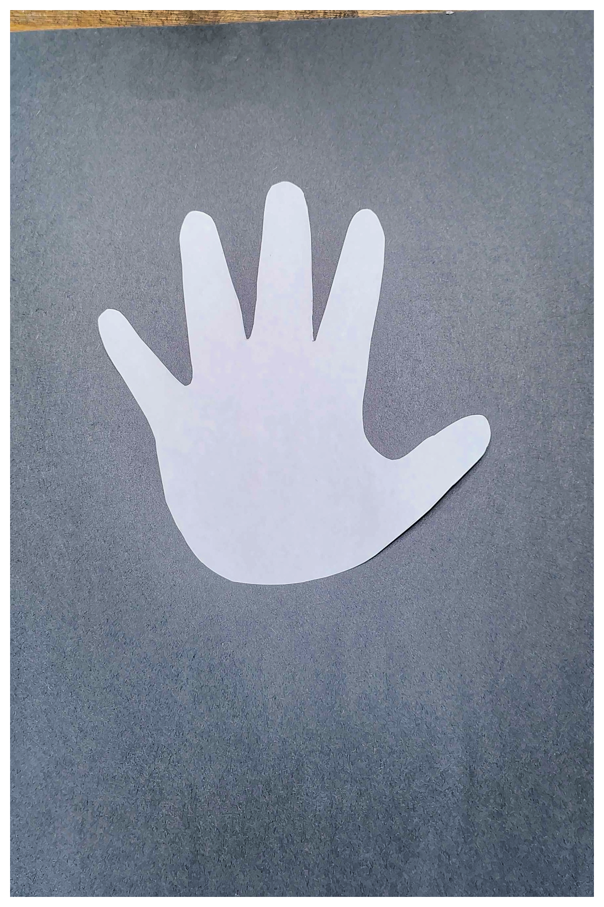 4th of July Craft- Step 2- White hand glued on black paper -Kids Activities Blog