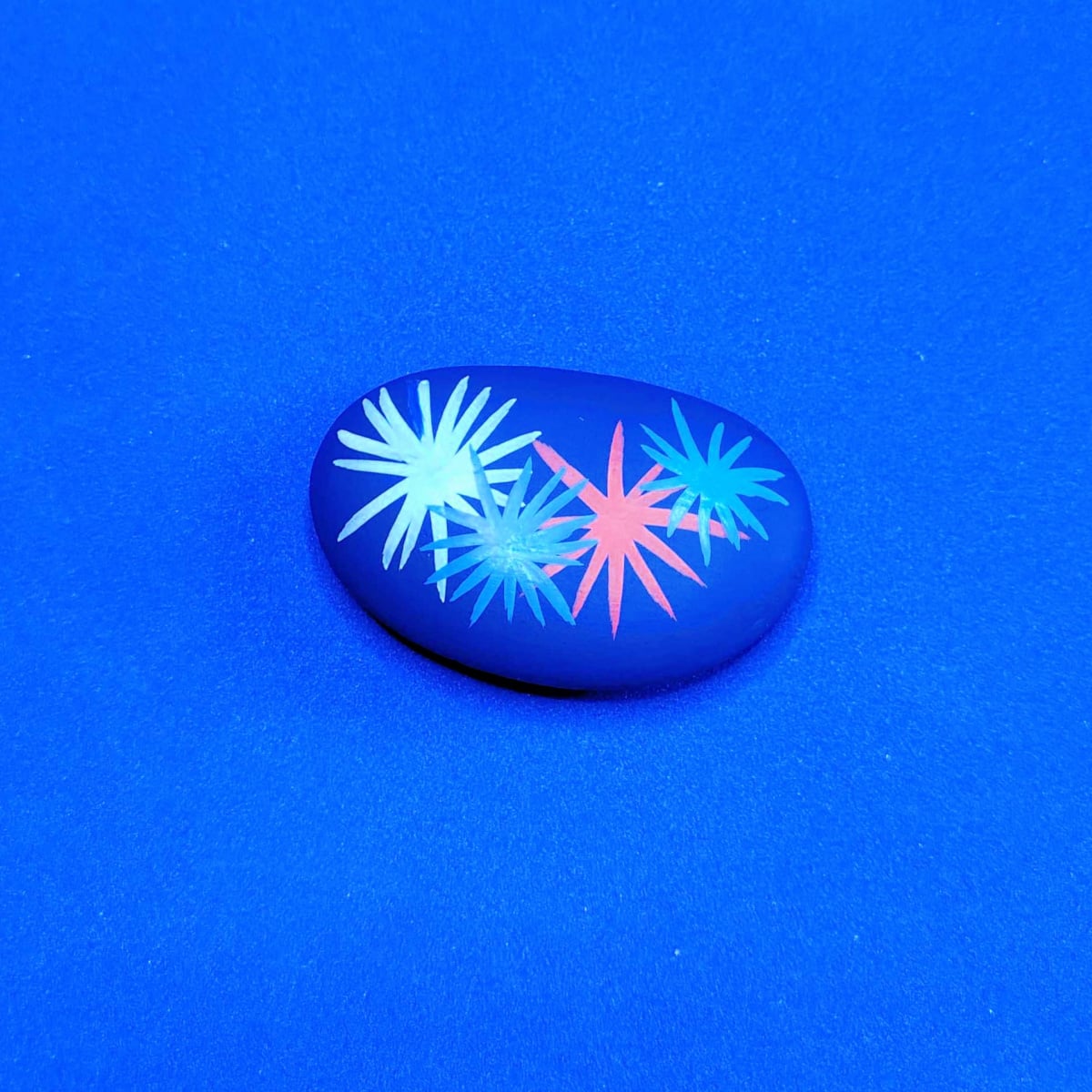 Patriotic Rock Painting Craft- blue rock with fire works -Kids Activities Blog
