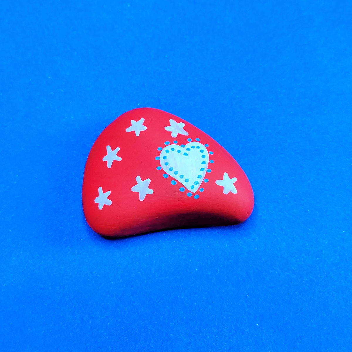 Patriotic Rock Painting Craft- red rock with white stars, heart, and blue dots -Kids Activities Blog
