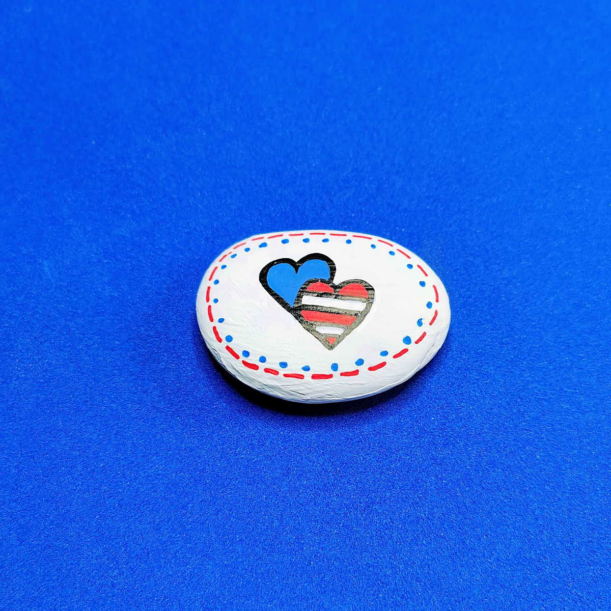 Patriotic Rock Painting Craft- red and white and blue heart with dots and lines -Kids Activities Blog