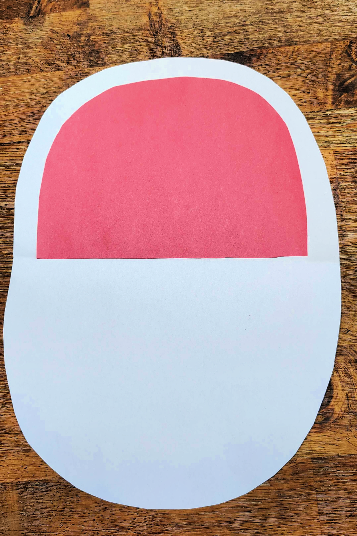 Watermelon Craft- Step 4- Red half circle glued on half the white oval -Kids Activities Blog