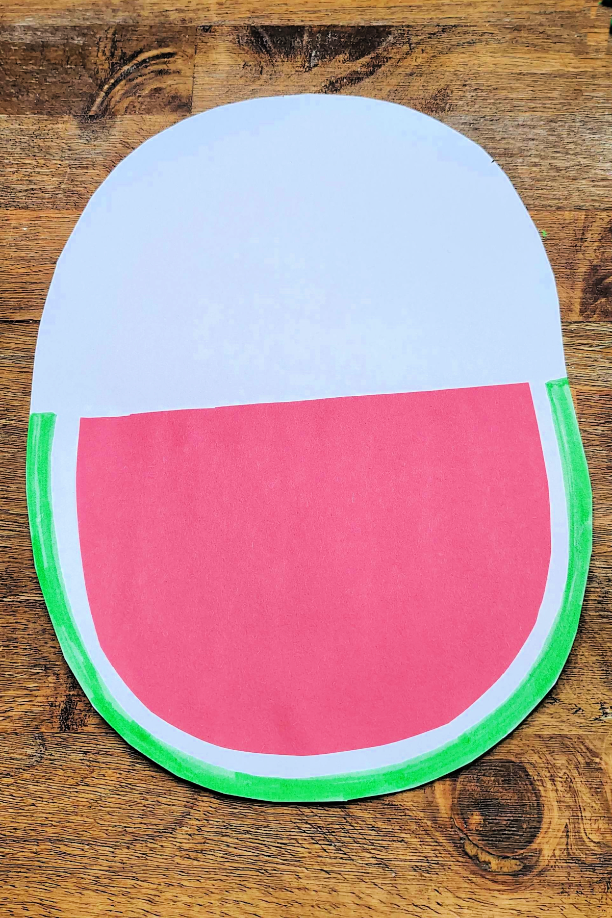 Watermelon Craft- Step 5- Green rind on the outside of white oval -Kids Activities Blog