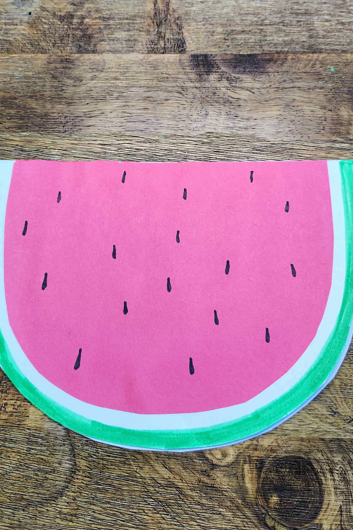 Watermelon Craft- Step 6- seeds on red watermelon -Kids Activities Blog