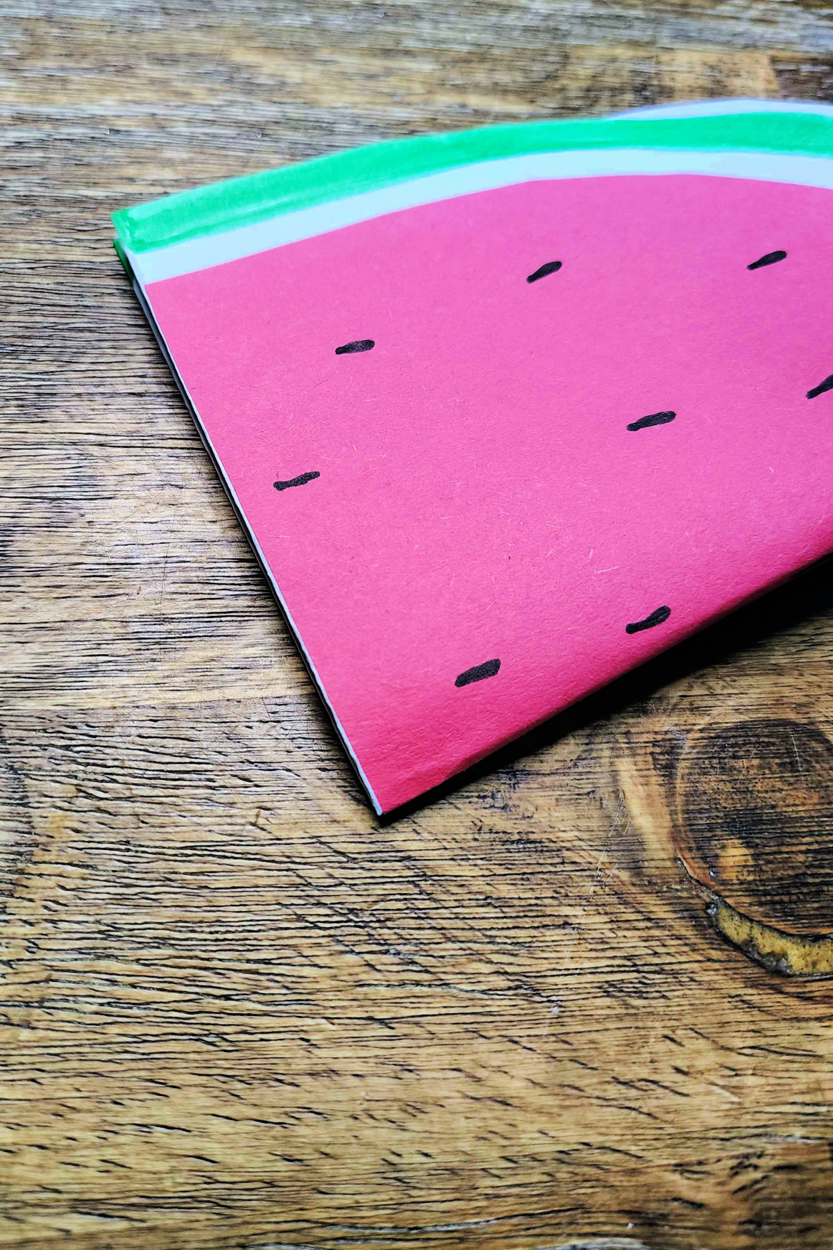 Watermelon Craft- Step 7- Glue flat side of watermelon down -Kids Activities Blog