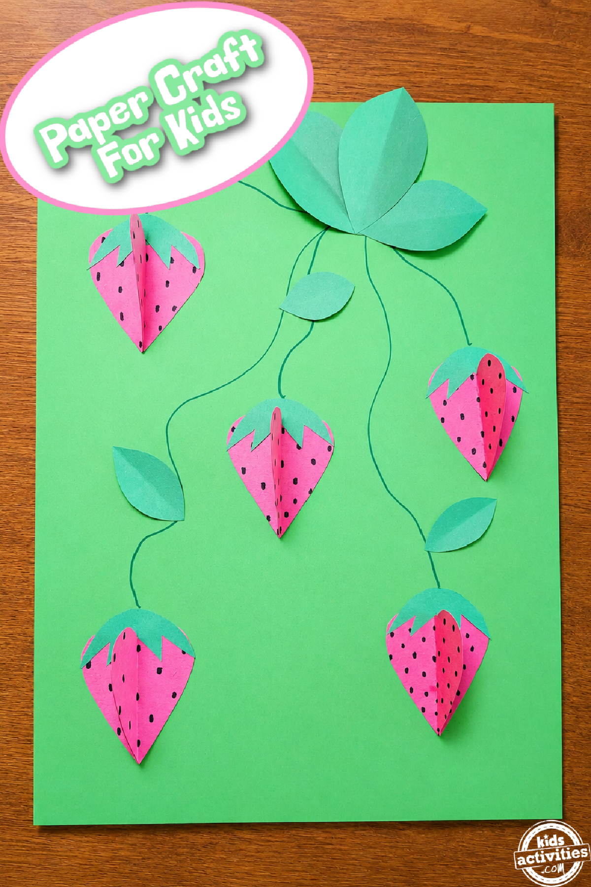 Strawberry Craft- - green and red strawberry craft on wood background- Kids Activities Blog