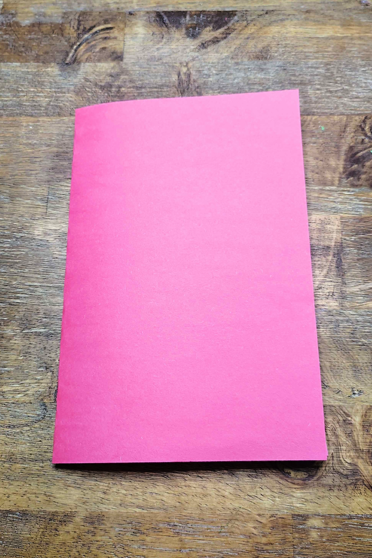 Strawberry Craft- Step 1- Red paper folded - Kids Activities Blog