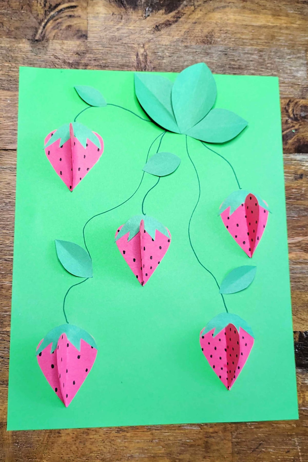 Strawberry Craft- Step 7 - Glue leaves on - Kids Activities Blog