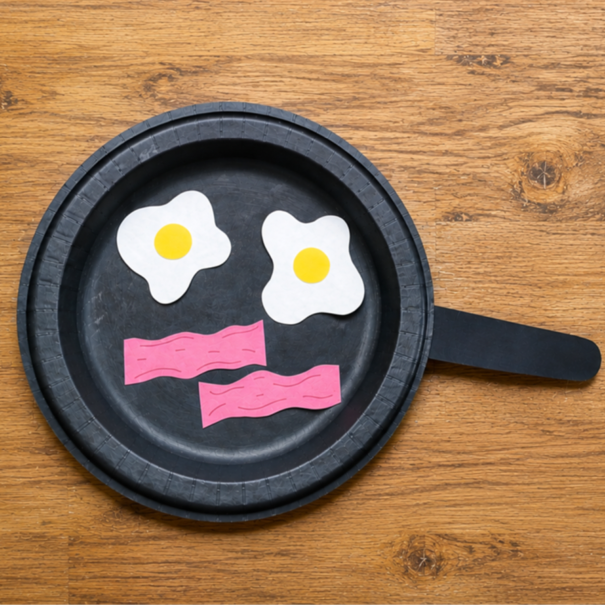Breakfast Craft Paper Plate with a handle, black with paper food on a wood background- kids activities blog