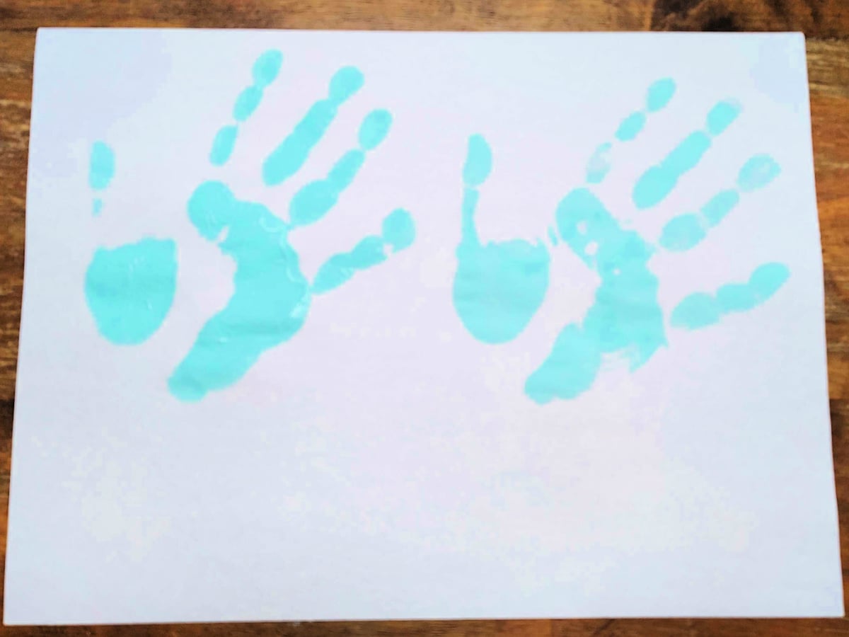 Jesus Feeds The 5000 Craft- Step 1- blue handprints on paper - Kids Activities Blog