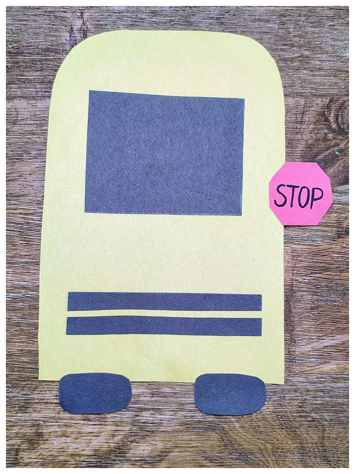 Paper School bus craft- Step 7- Glue the stop sign to the bus- Kids Activities Blog