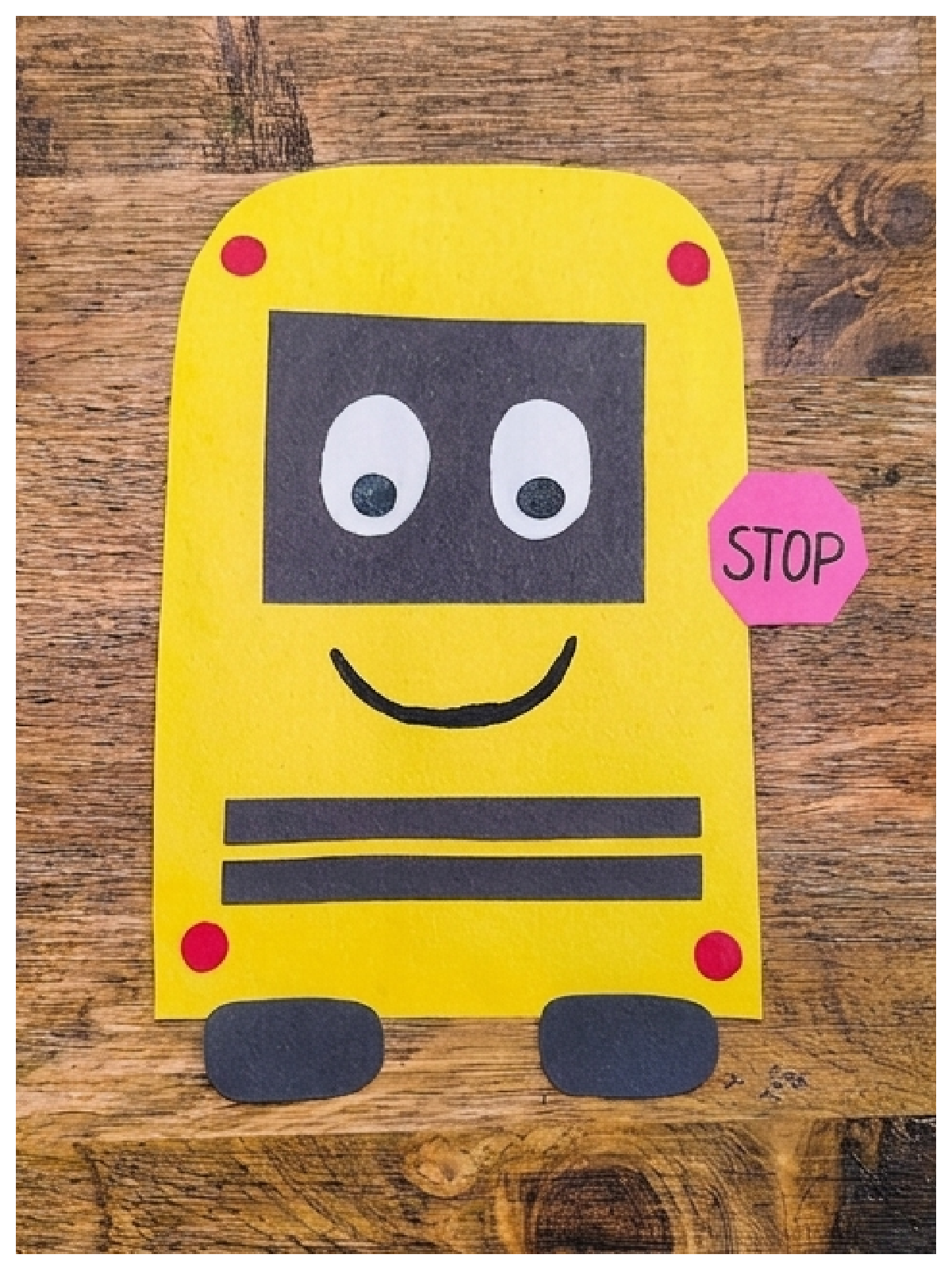 Paper School bus craft- Step 7- face and lights put on school bus- Kids Activities Blog