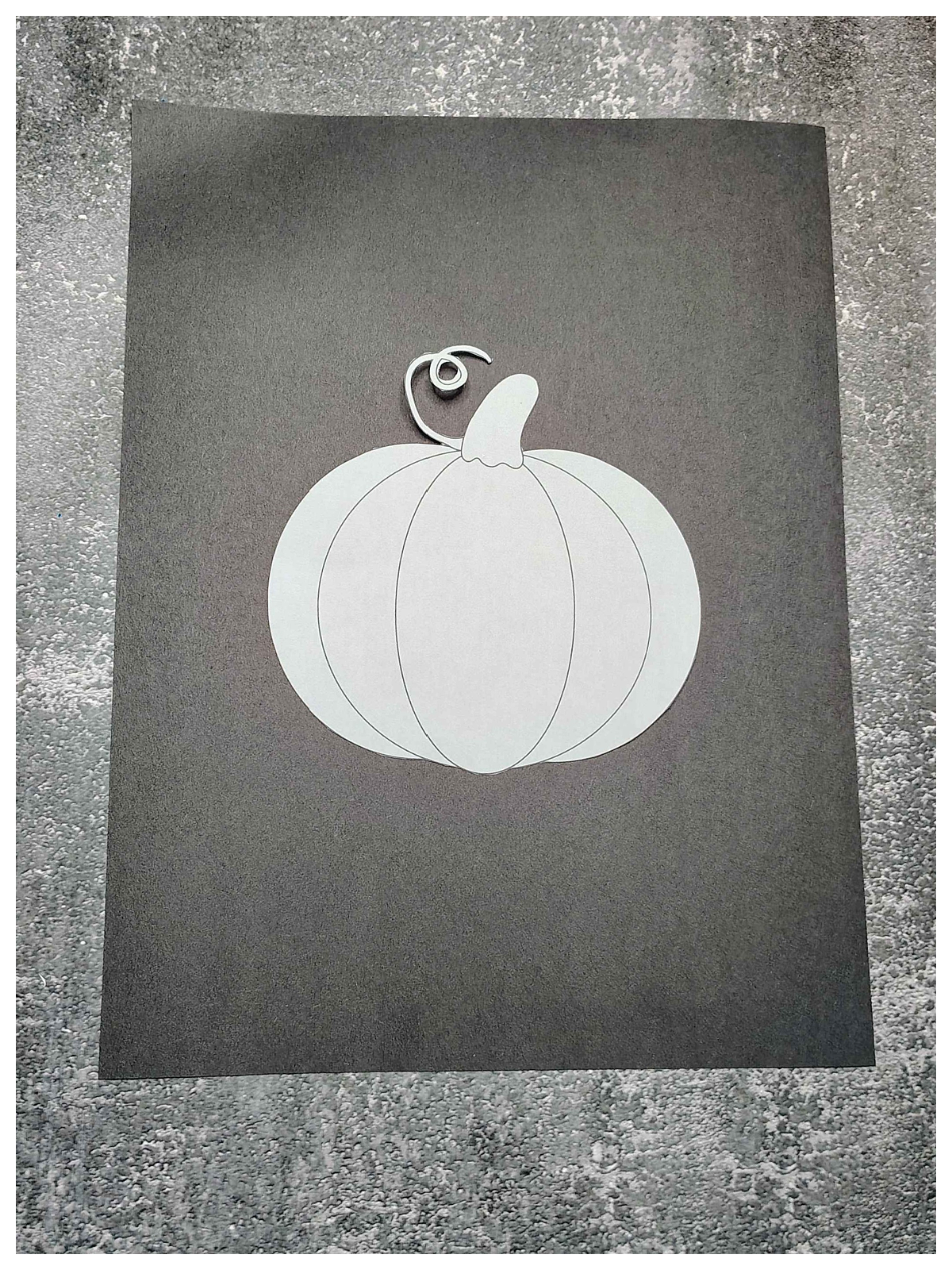 Pumpkin Craft- Step 1- pumpkin on black construction paper - Kids Activities Blog