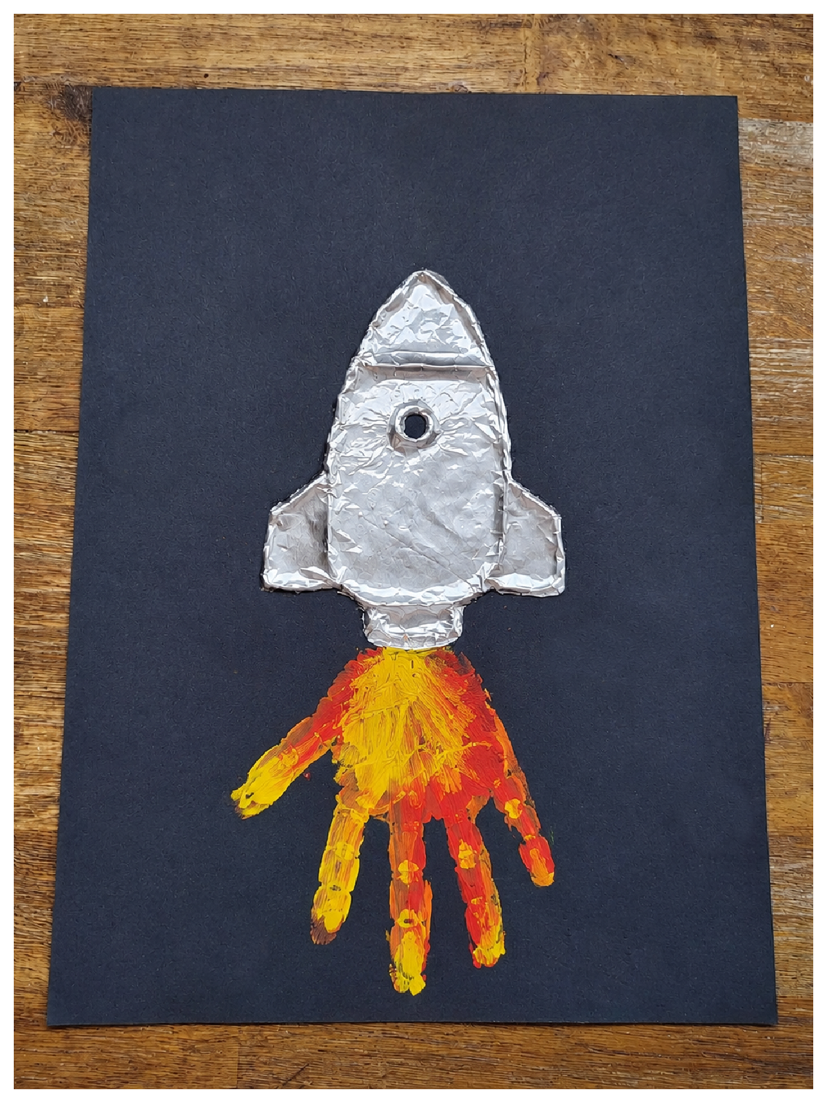 Rocket Craft- Step 4- Red yellow and orange handprint flames-Kids Activities Blog