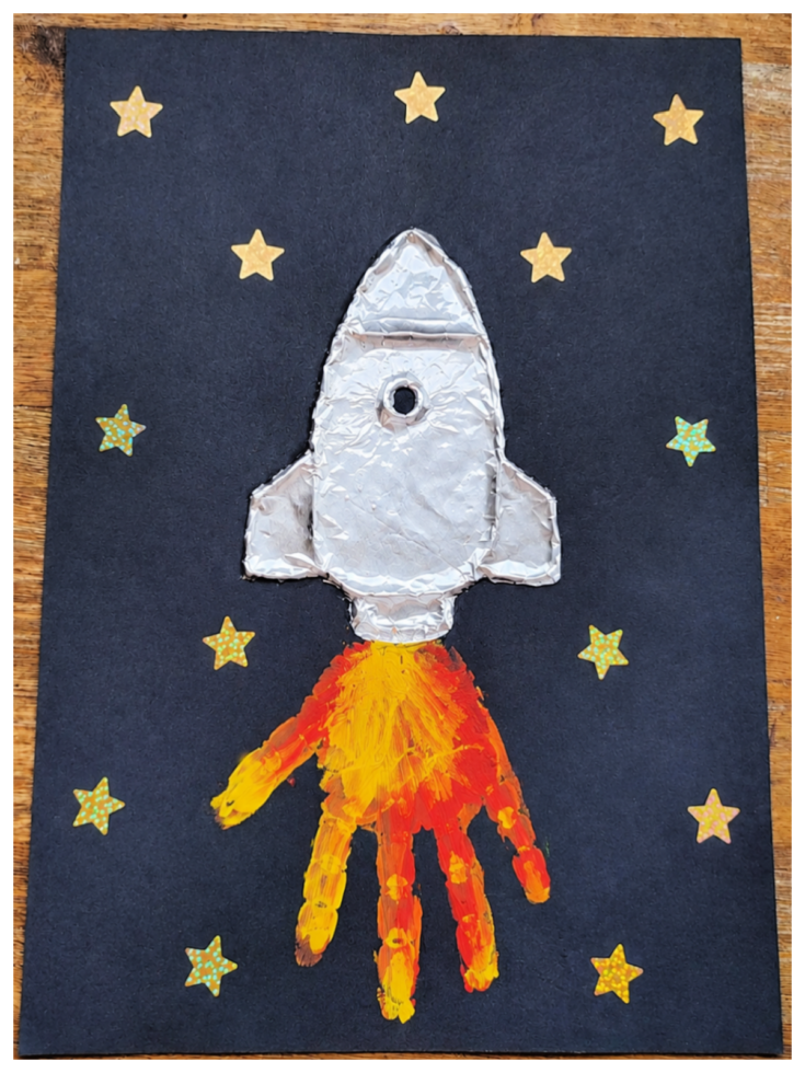 Rocket Craft- Step 5 - Add gold stars to the black paper -Kids Activities Blog