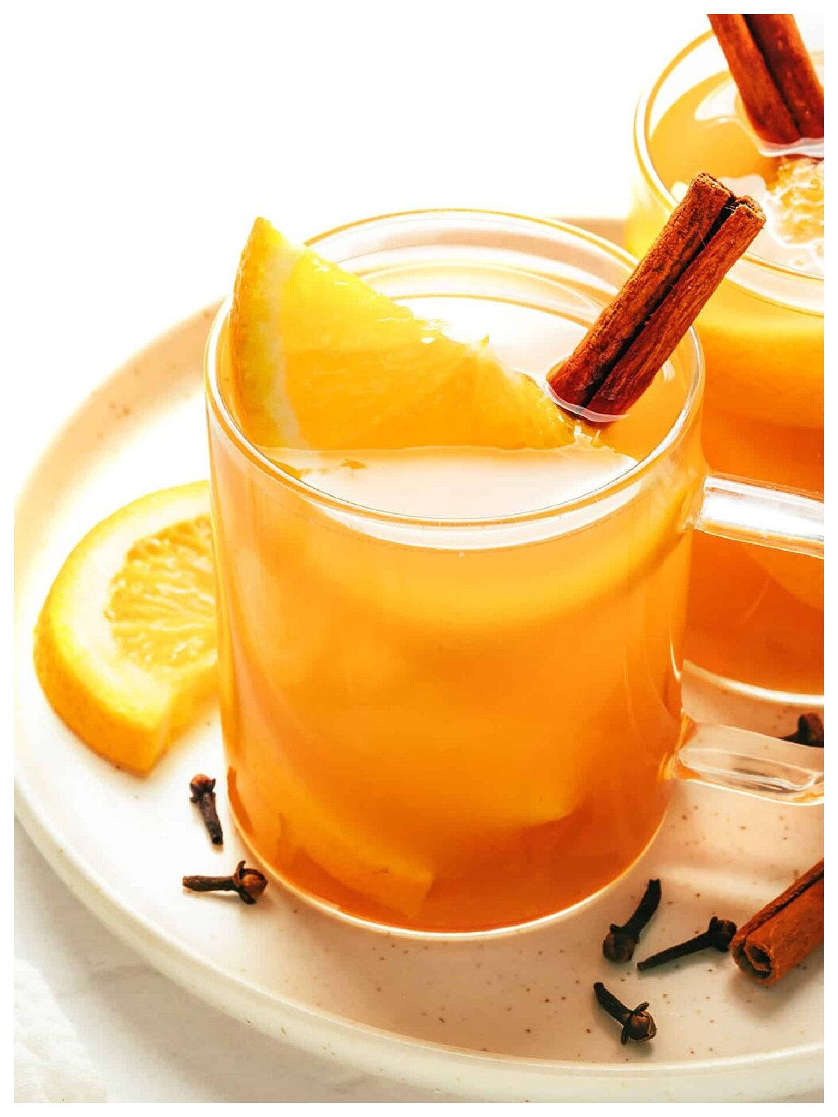 Apple Cider Recipes- apple cider in a glass with orange and cinnamon -Kids Activities Blog