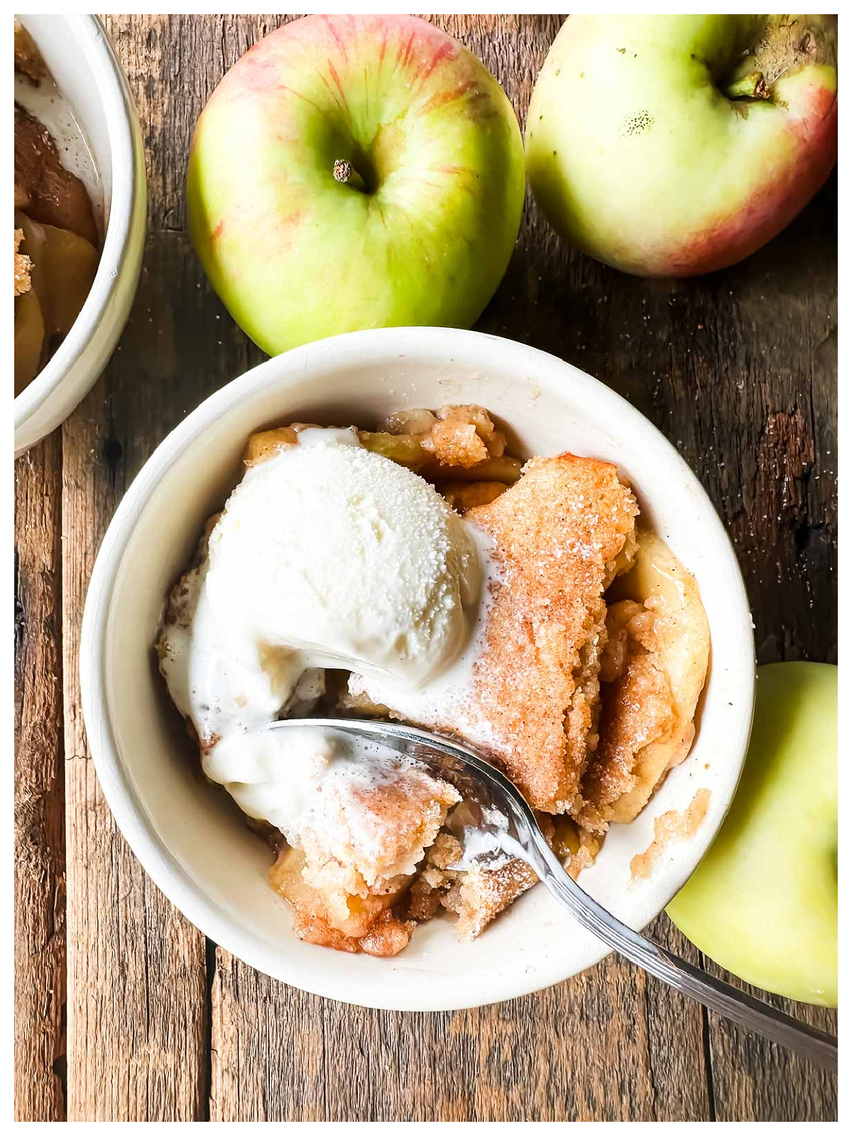 Apple Cider Recipes- cobbler in a bowl with ice cream apples next to it-Kids Activities Blog