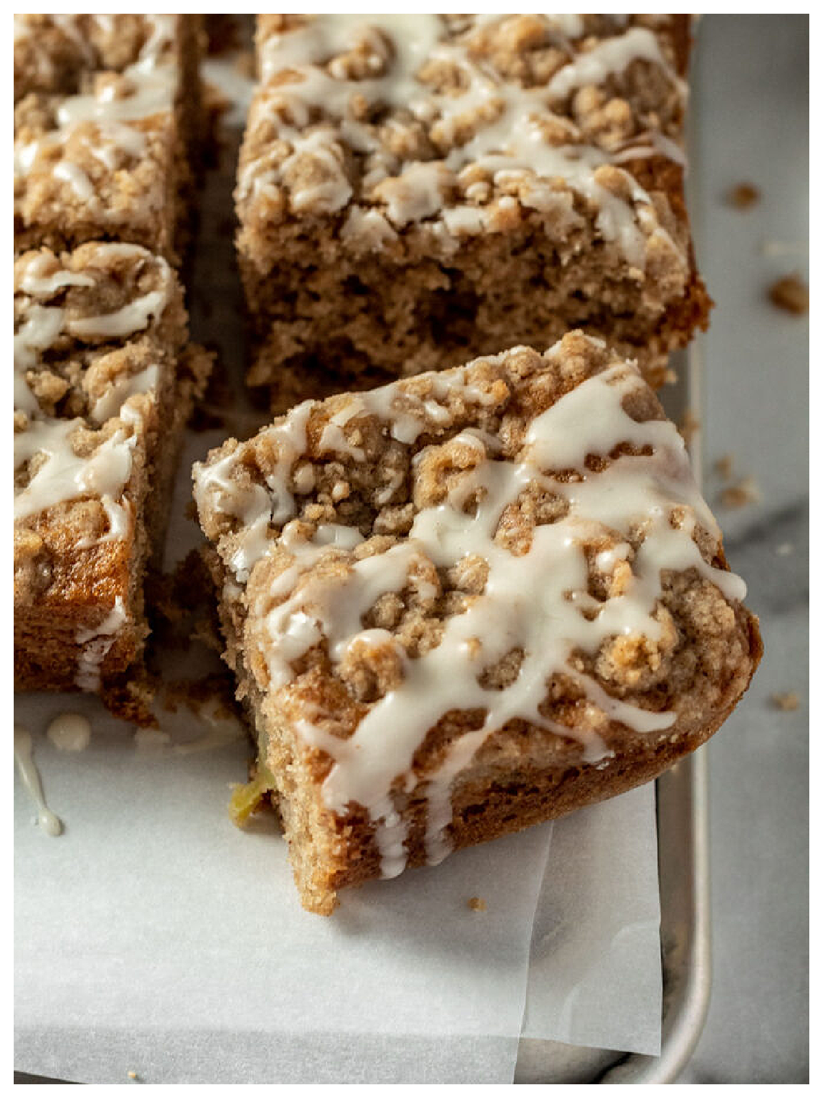 Apple Cider Recipes- coffee cake with icing in a pan cut into squares-Kids Activities Blog