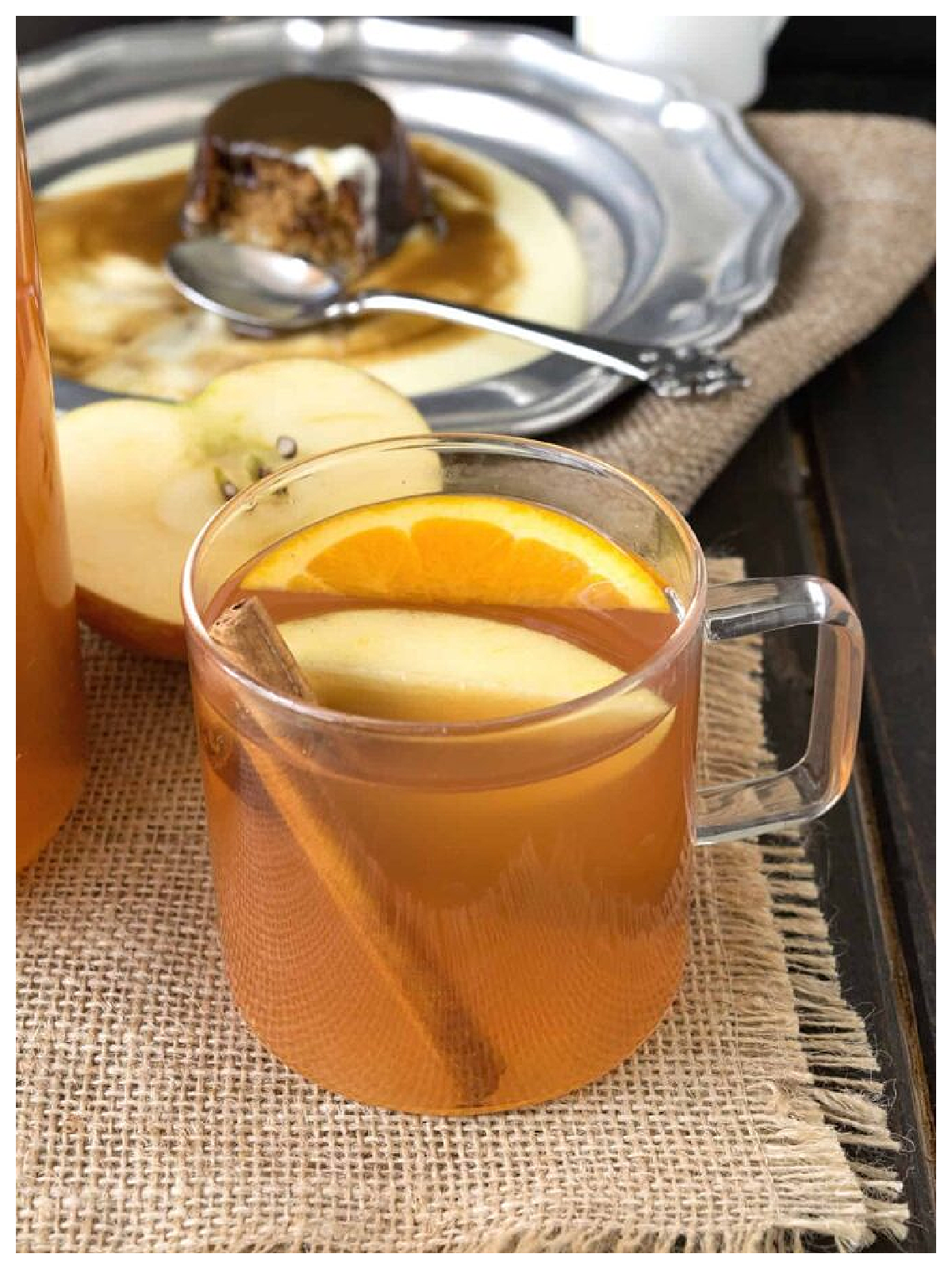 Apple Cider Recipes- glass of juice with orange and apple and dessert in the background-Kids Activities Blog